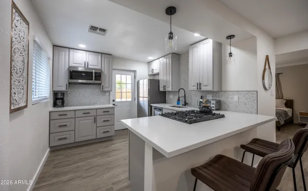 a kitchen with sink cabinets and refrigerator
