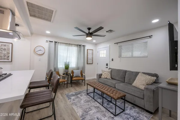 a living room with furniture ceiling fan and a window