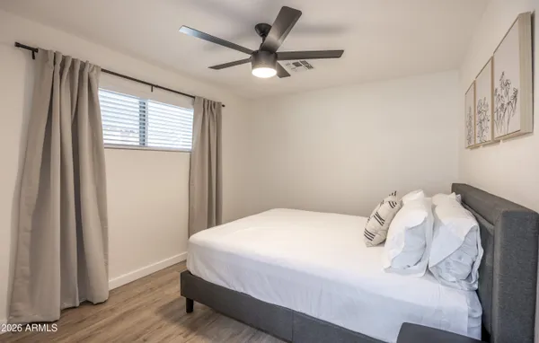 a bedroom with a bed and a window