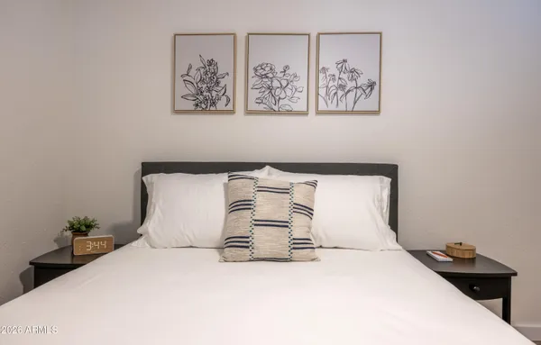 a bedroom with a bed and wall painting