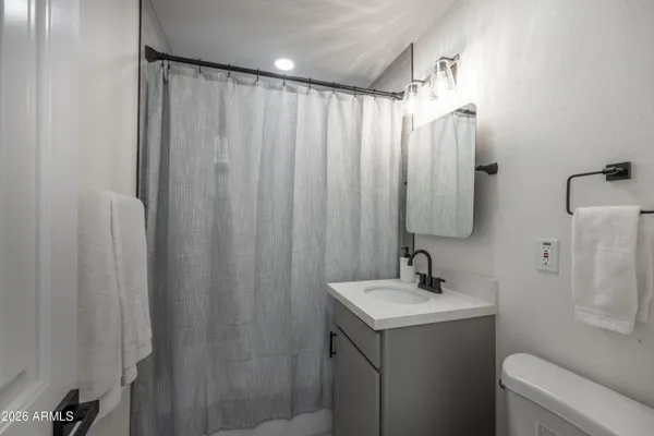 a bathroom with a shower curtain and a sink
