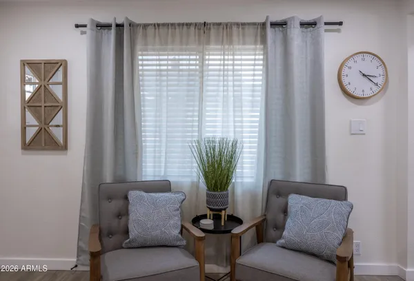 a view of a livingroom with furniture and a window