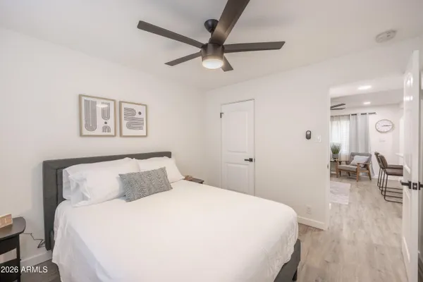 a bedroom with a bed and a chandelier