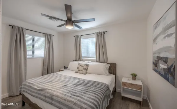 a bedroom with a bed and a large window
