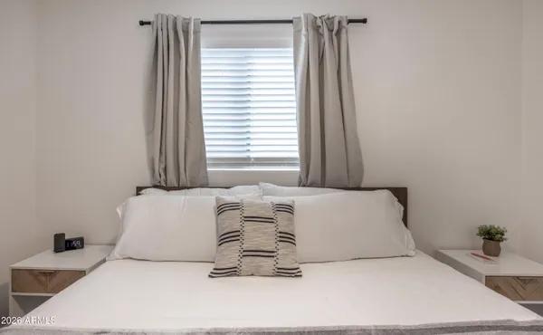 a bedroom with a bed and a window