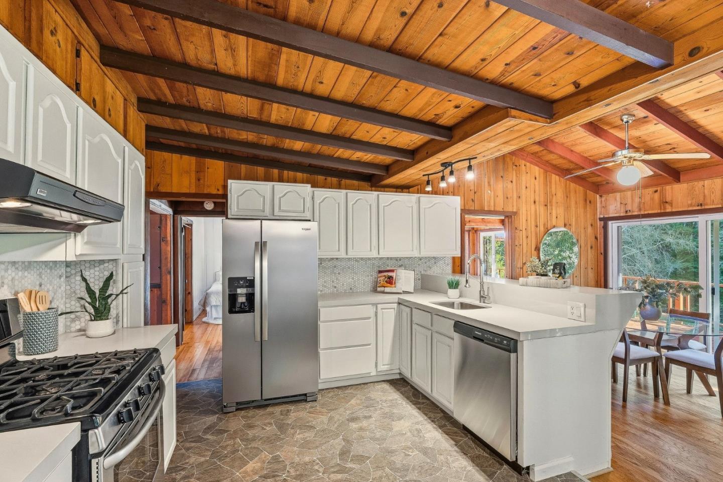 194 Lazy Woods Road Felton, CA 95018 - Photo 21 of 58 a kitchen with stainless steel appliances a refrigerator a sink a stove and white cabinets with wooden floor