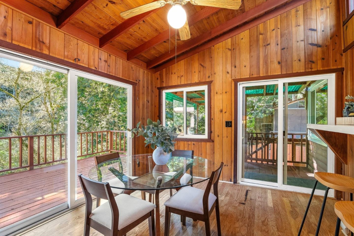 194 Lazy Woods Road Felton, CA 95018 - Photo 29 of 58 a dining room with wooden floor windows and outdoor view