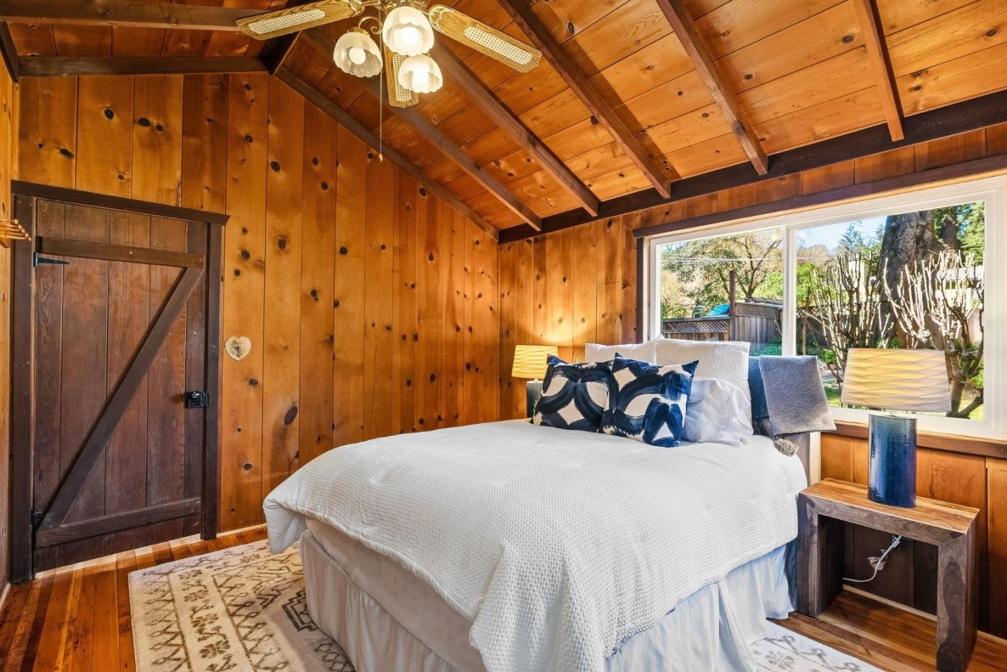 194 Lazy Woods Road Felton, CA 95018 - Photo 32 of 58 a bedroom with a bed a dresser next to a window
