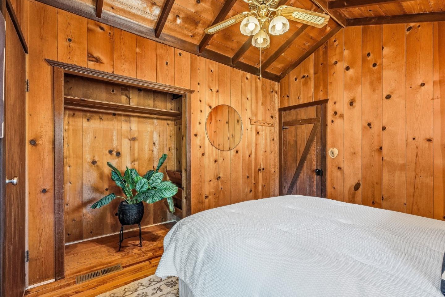 194 Lazy Woods Road Felton, CA 95018 - Photo 34 of 58 a bedroom with a bed and a potted plant