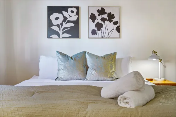 a large bed sitting next to a white wall