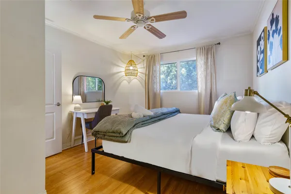 a bedroom with a bed window and a table