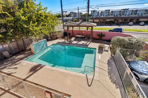 a view of a swimming pool with sitting area