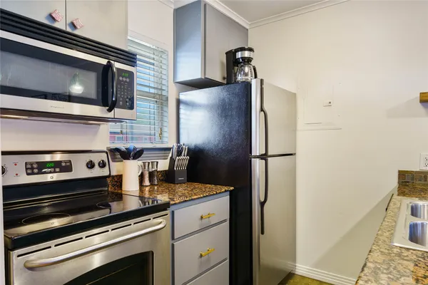 a kitchen with a refrigerator stove and microwave