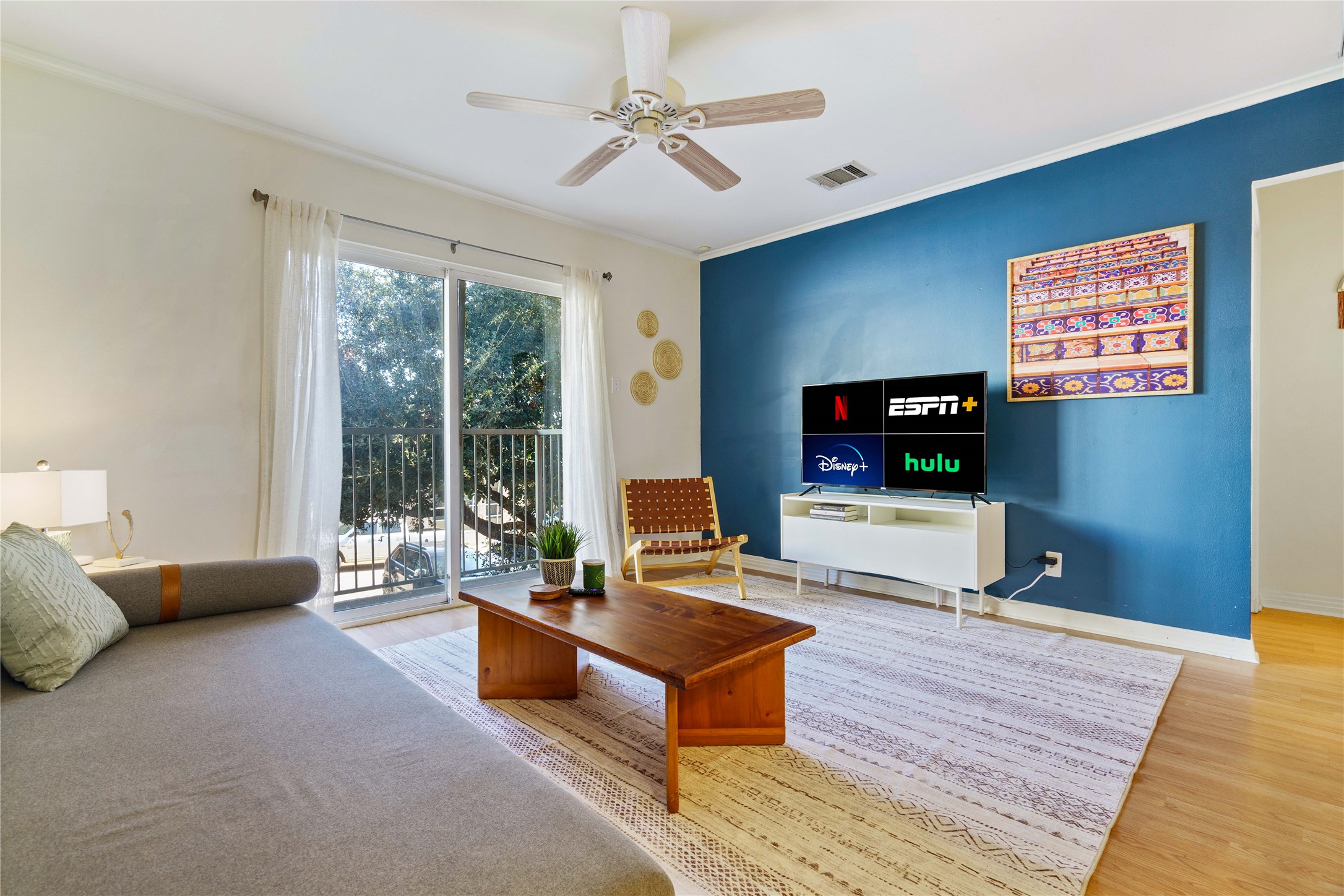 1422 Collier Street, Unit 214 Austin, TX 78704 - Photo 7 of 25 a living room with furniture and a flat screen tv