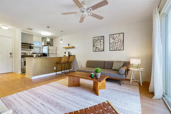 a living room with furniture and kitchen view