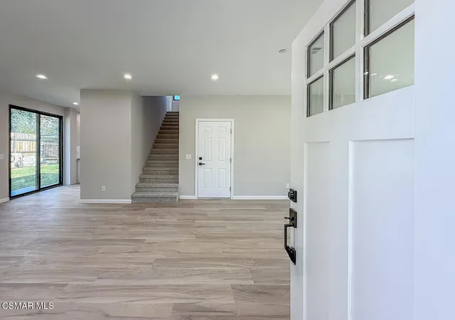 a view of an entryway with wooden floor