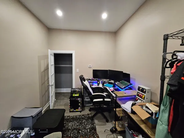 a view of a workspace with furniture and wooden floor