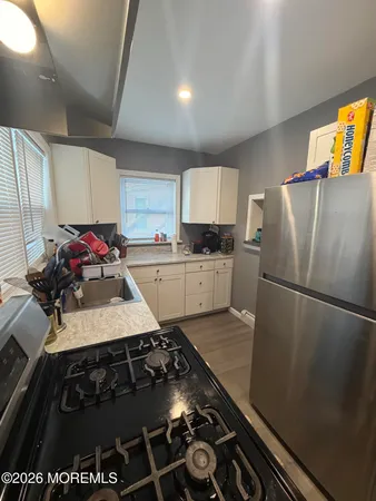 a kitchen with a stove and a refrigerator