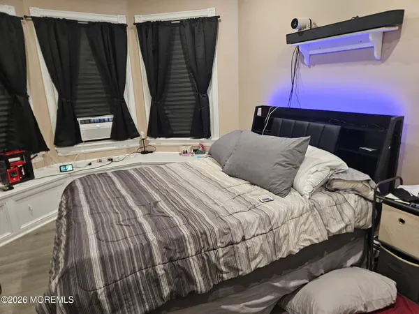 a bedroom with a bed a mirror and dresser