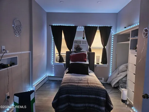 a bed sitting in a bedroom next to a window