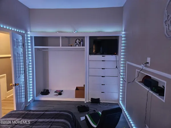 a bedroom with a bed and a television