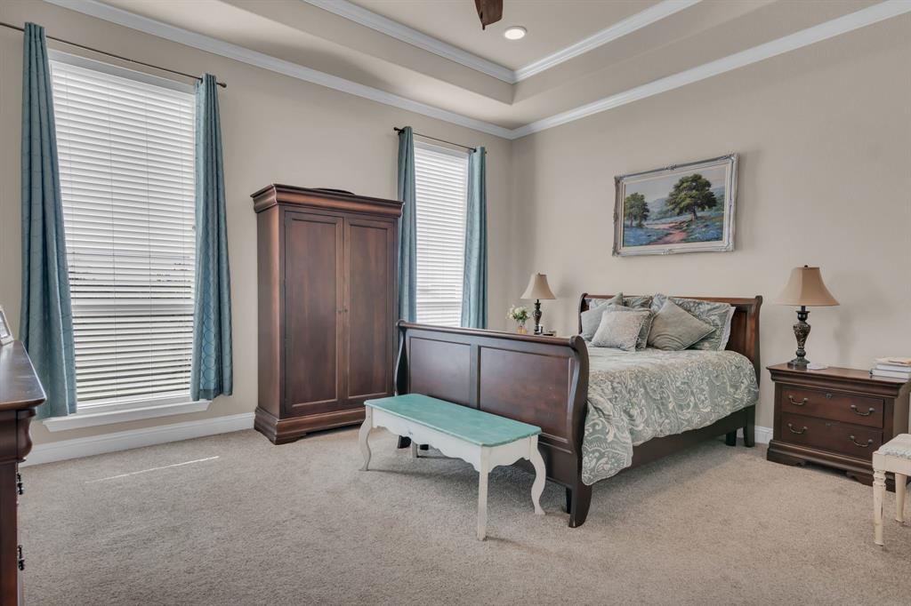 7728 County Road 1205 Rio Vista, TX 76093 - Photo 17 of 31 Bedroom featuring light colored carpet, crown molding, a raised ceiling, a ceiling fan, and recessed lighting