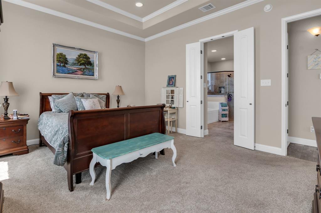 7728 County Road 1205 Rio Vista, TX 76093 - Photo 18 of 31 Bedroom featuring light carpet, recessed lighting, ornamental molding, and a raised ceiling
