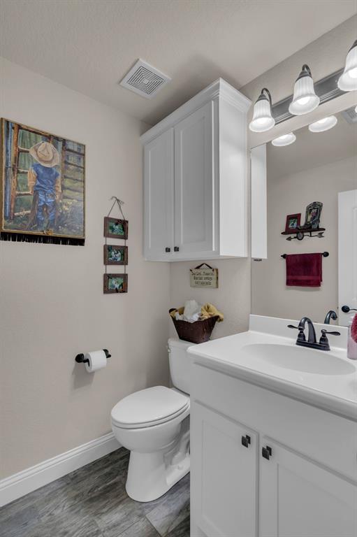 7728 County Road 1205 Rio Vista, TX 76093 - Photo 21 of 31 Bathroom with vanity and wood finished floors