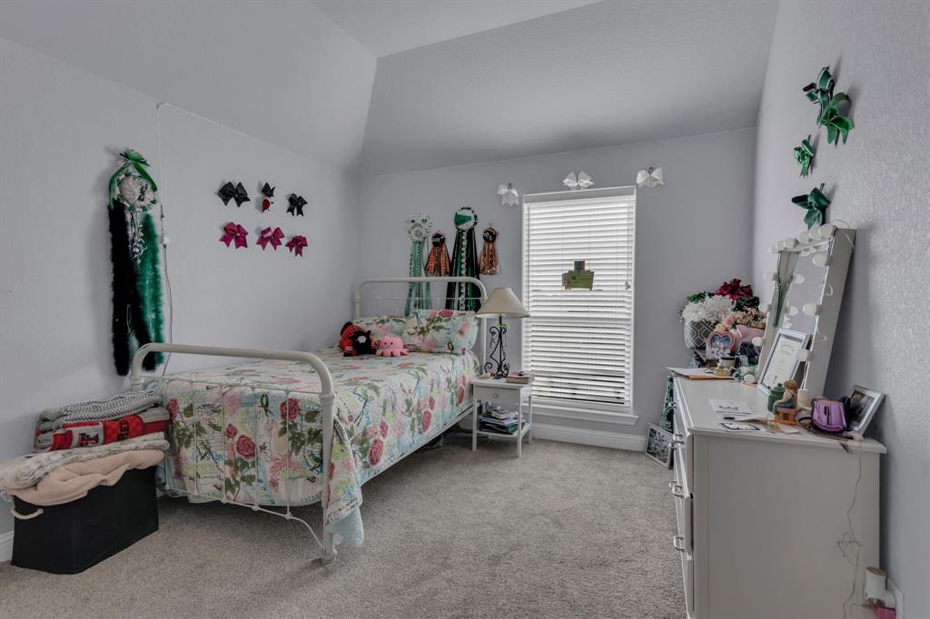 7728 County Road 1205 Rio Vista, TX 76093 - Photo 23 of 31 Bedroom with light carpet and lofted ceiling