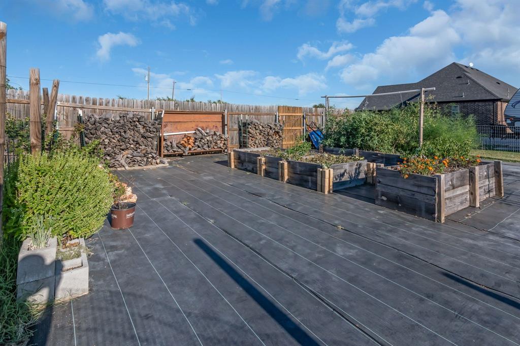 7728 County Road 1205 Rio Vista, TX 76093 - Photo 28 of 31 Deck with a vegetable garden and a fenced backyard