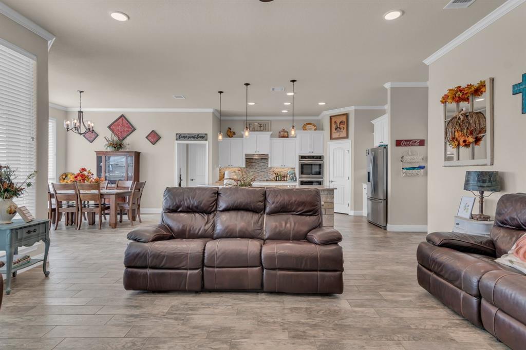 7728 County Road 1205 Rio Vista, TX 76093 - Photo 10 of 31 Living area featuring crown molding, light wood-type flooring, a chandelier, and recessed lighting