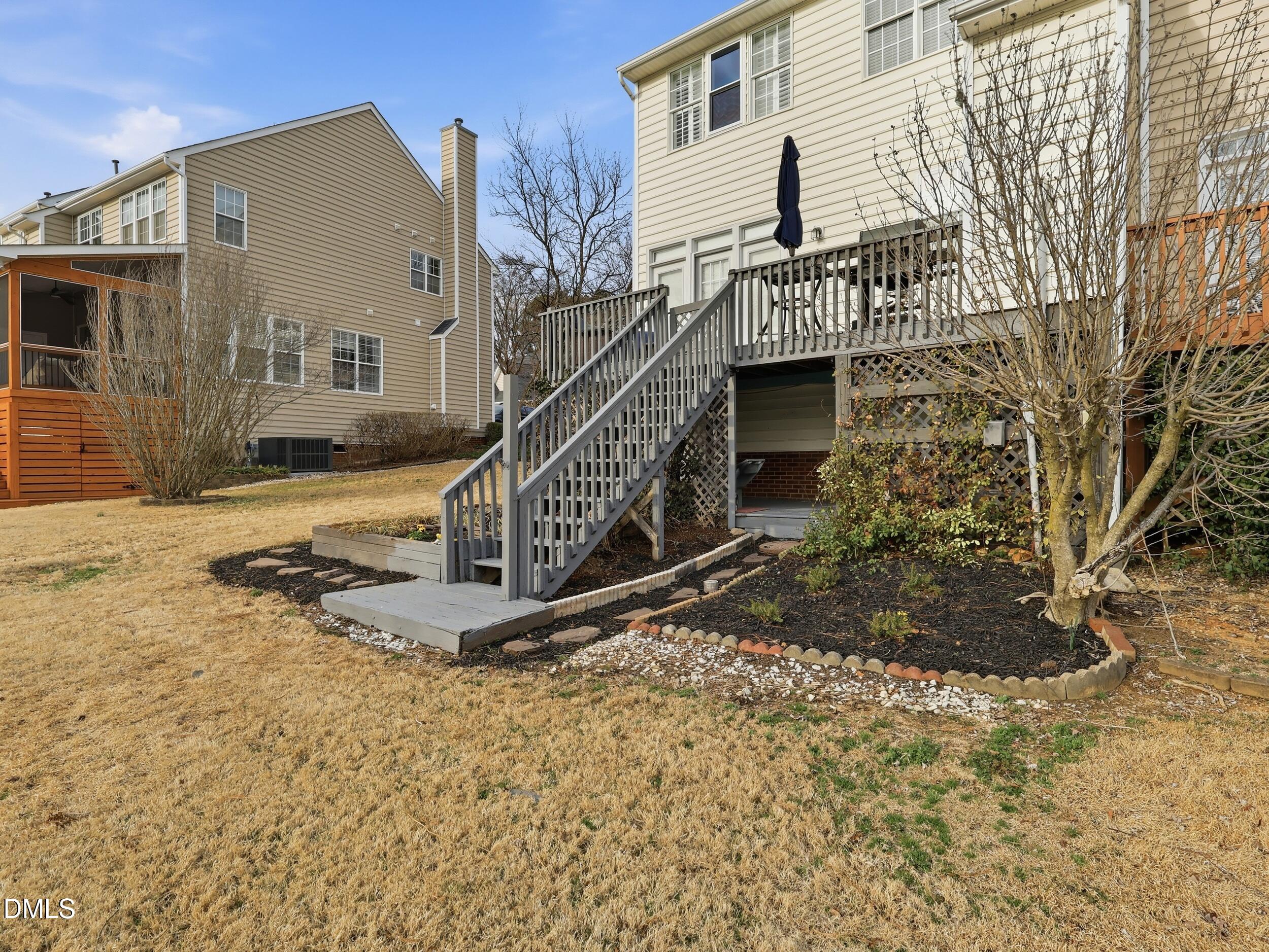 300 Nottinghill Walk Apex, NC 27502 - Photo 14 of 29 a view of a house with a small yard and wooden deck