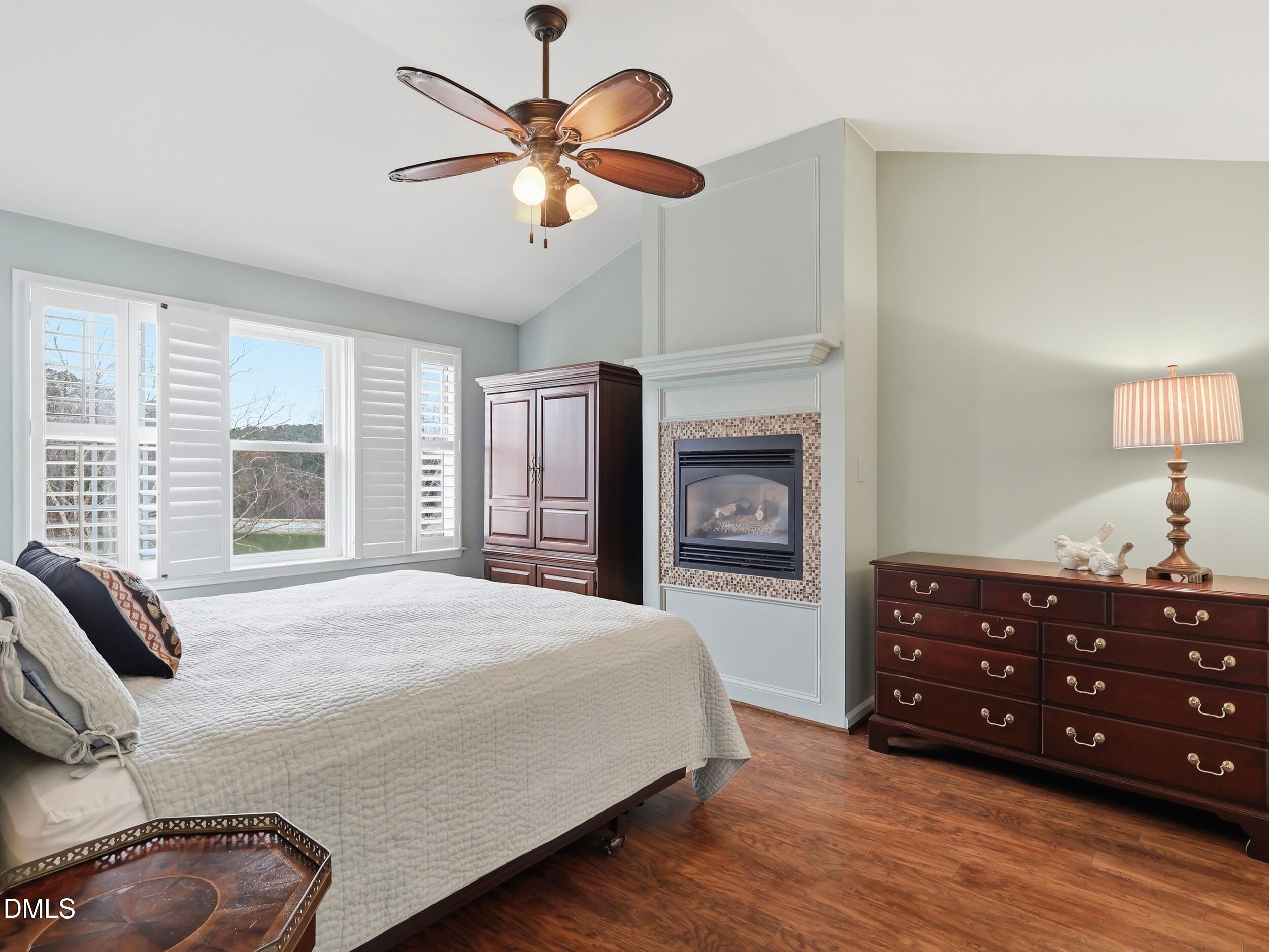 300 Nottinghill Walk Apex, NC 27502 - Photo 16 of 29 a bedroom with a bed a chandelier and a dresser
