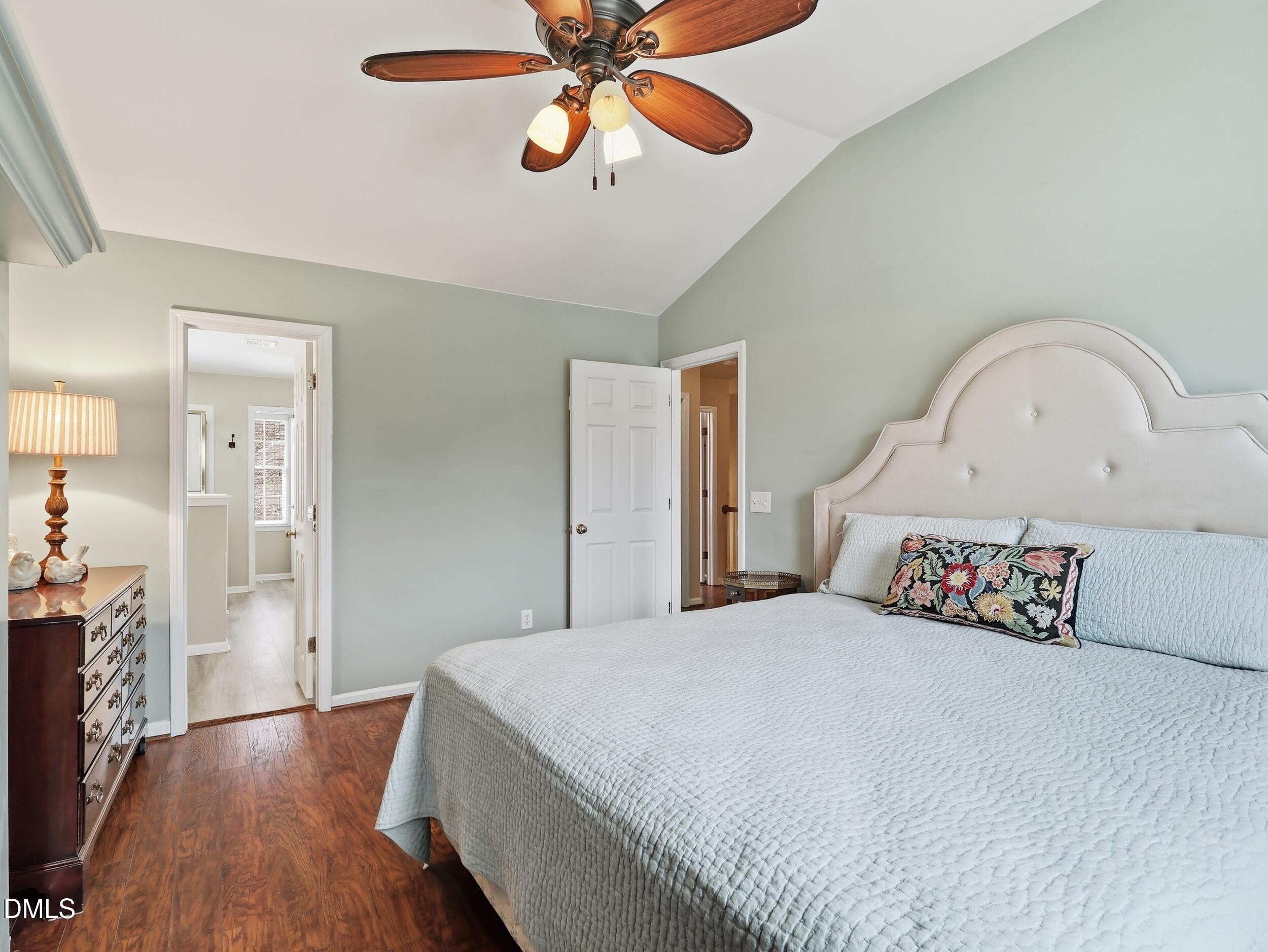 300 Nottinghill Walk Apex, NC 27502 - Photo 17 of 29 a bedroom with a bed and a chandelier