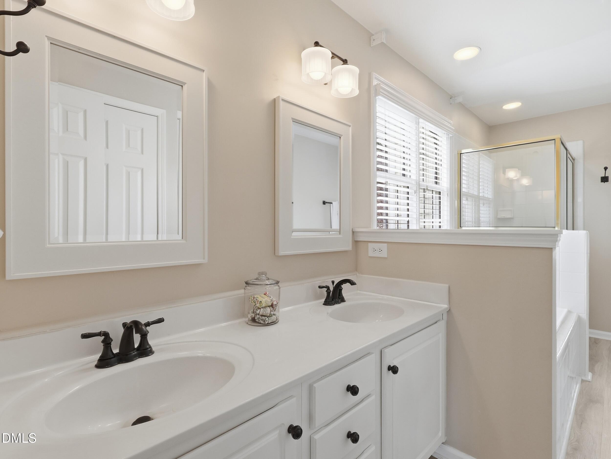 300 Nottinghill Walk Apex, NC 27502 - Photo 19 of 29 a bathroom with double vanity sink a mirror and a window