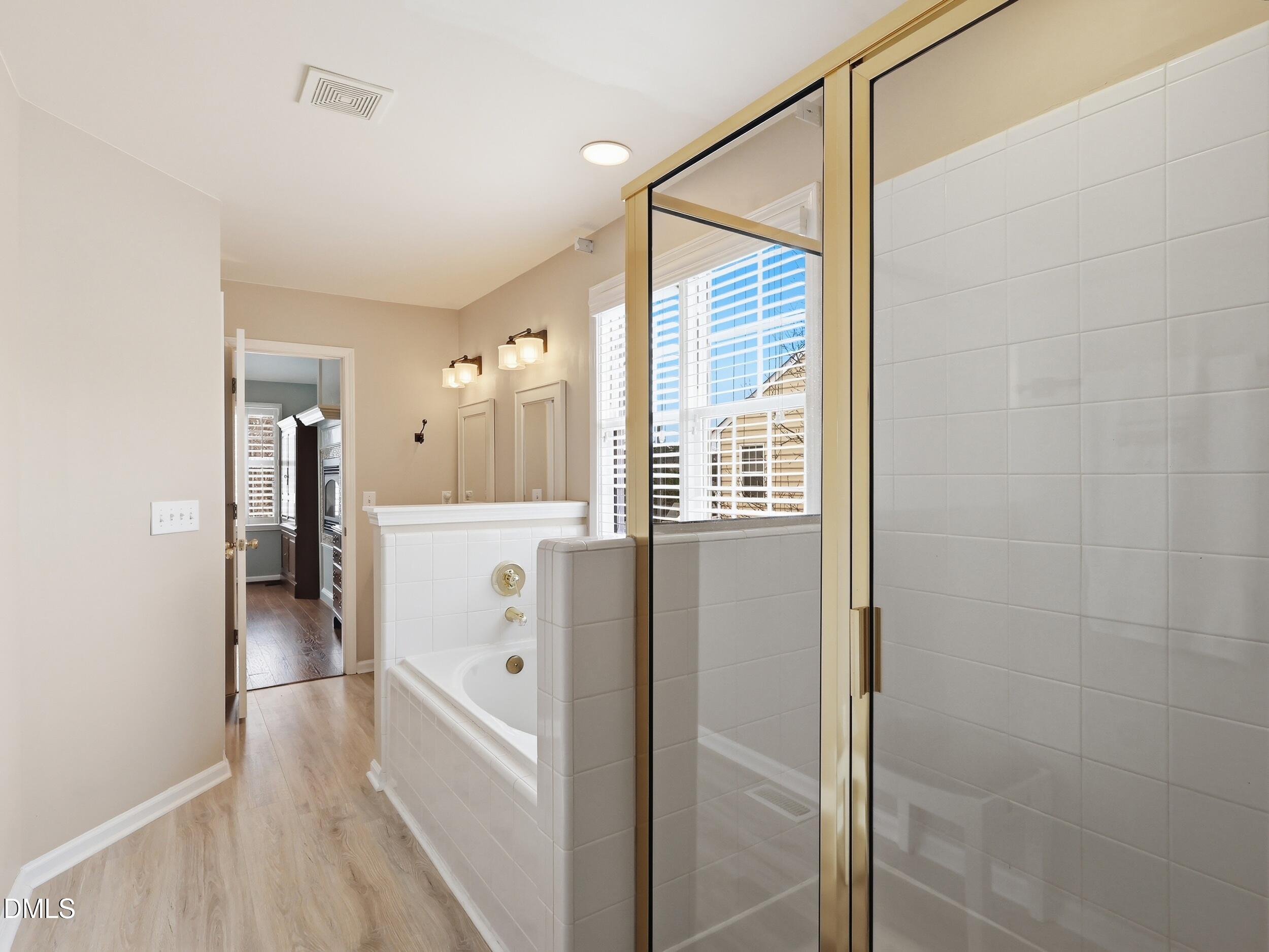 300 Nottinghill Walk Apex, NC 27502 - Photo 20 of 29 a view of a hallway with white cabinets and wooden floor