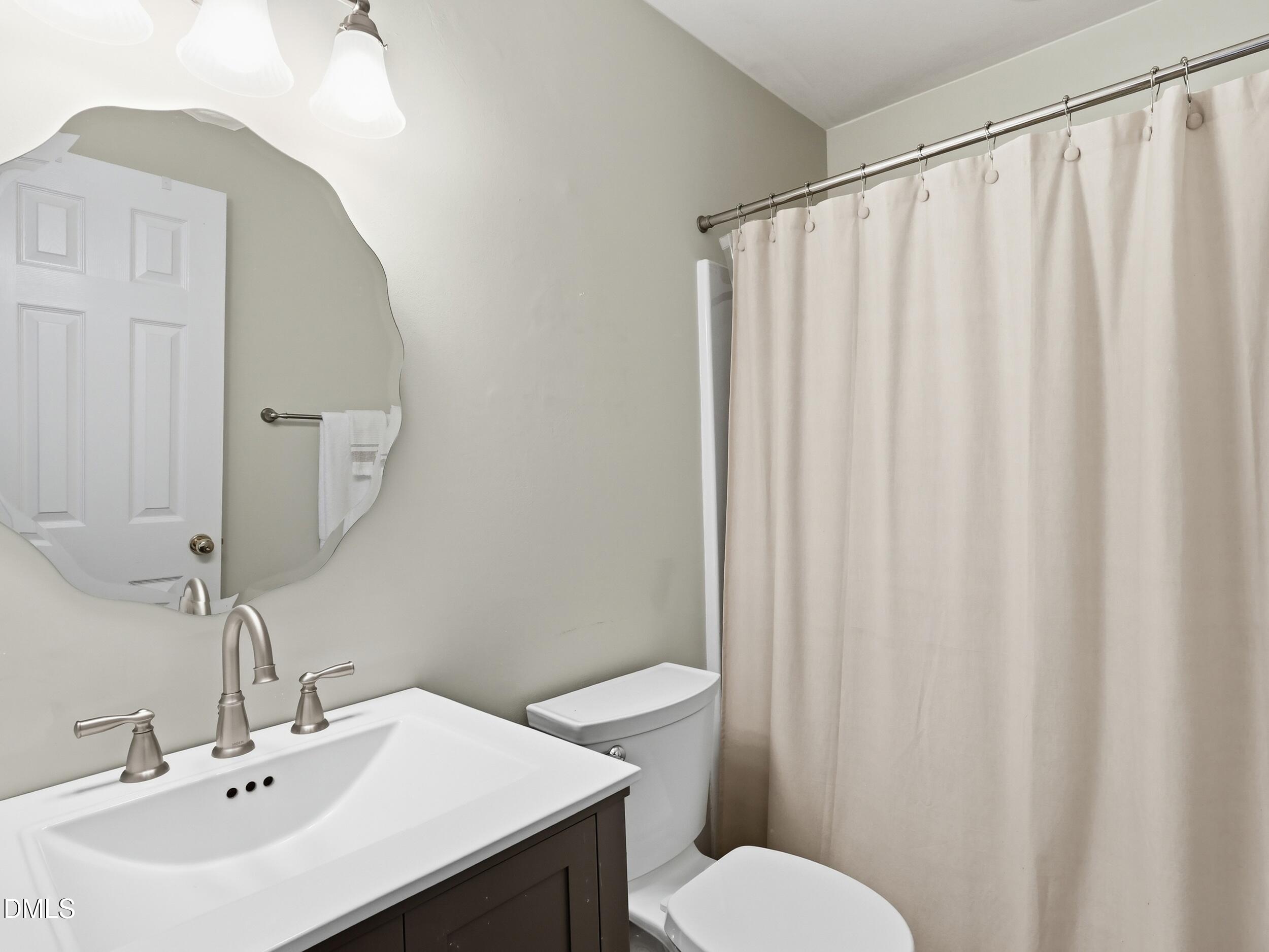 300 Nottinghill Walk Apex, NC 27502 - Photo 23 of 29 a bathroom with a sink and a mirror