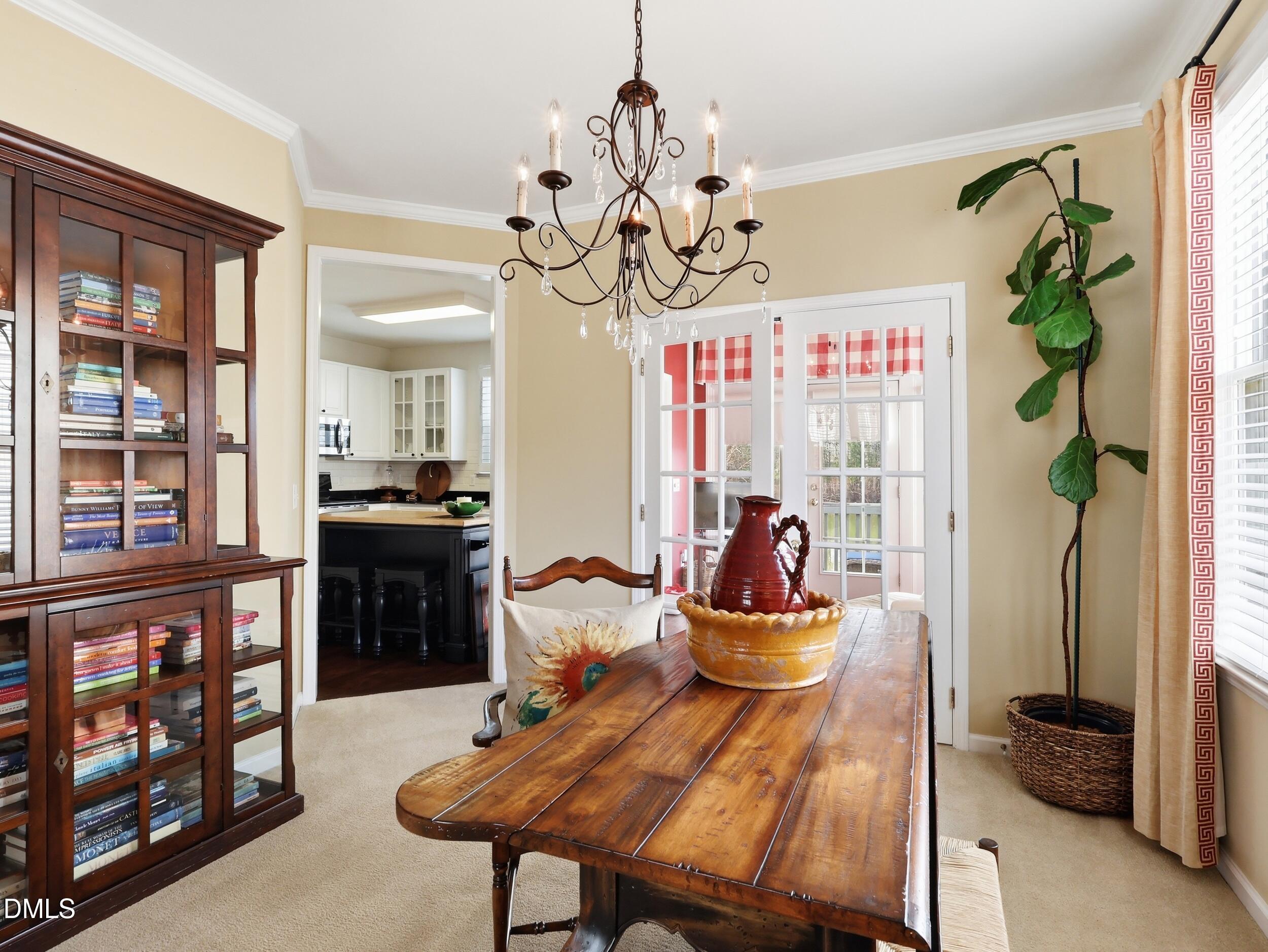 300 Nottinghill Walk Apex, NC 27502 - Photo 7 of 29 a dining room with furniture a livingroom and chandelier