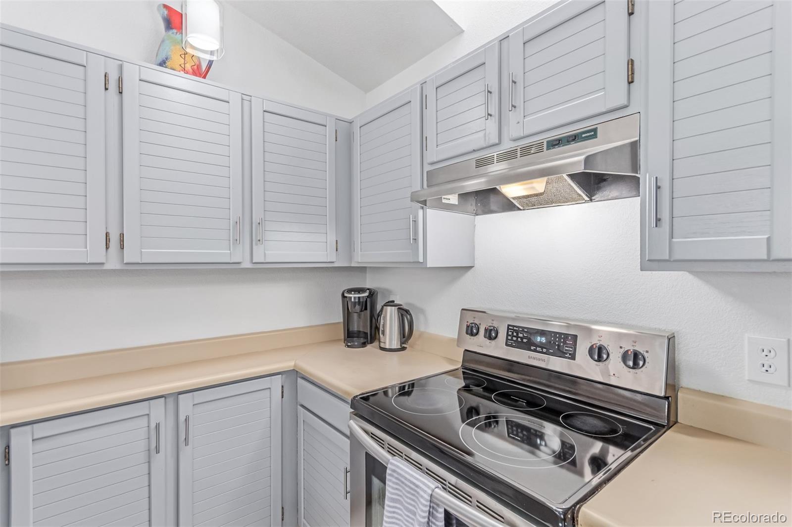 2675 South Deframe Circle Lakewood, CO 80228 - Photo 11 of 28 a kitchen with stainless steel appliances a sink a stove and cabinets