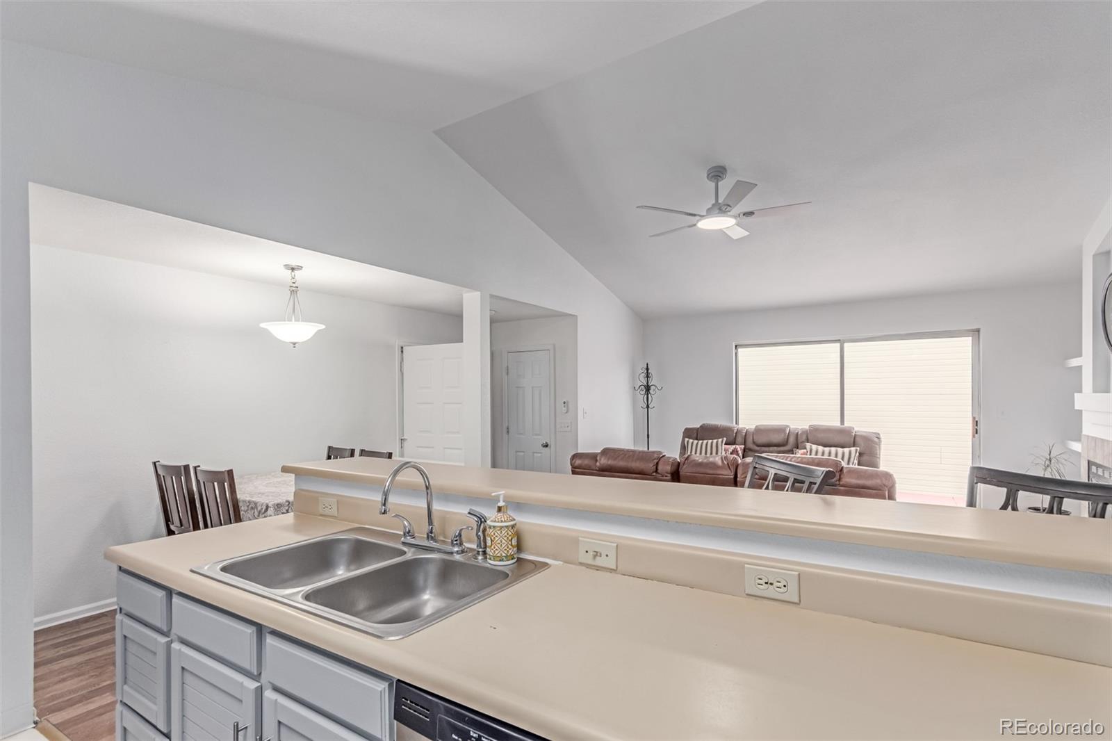 2675 South Deframe Circle Lakewood, CO 80228 - Photo 12 of 28 a kitchen with a sink cabinets and a window