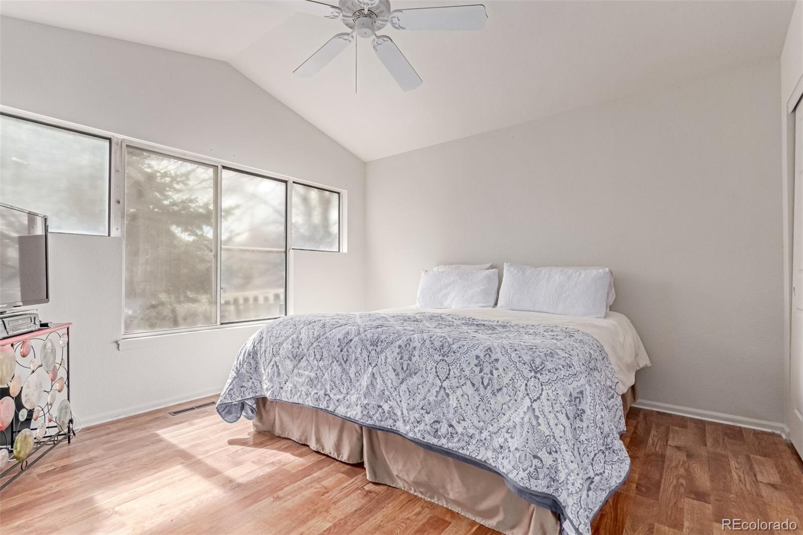 2675 South Deframe Circle Lakewood, CO 80228 - Photo 13 of 28 a bedroom with a bed and window