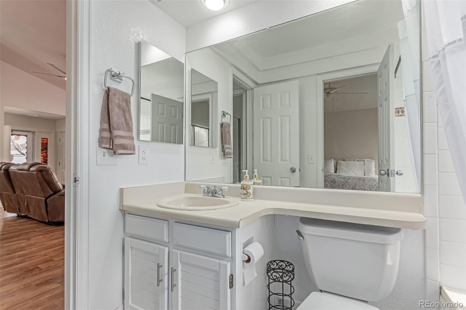 2675 South Deframe Circle Lakewood, CO 80228 - Photo 15 of 28 a bathroom with a sink and a mirror