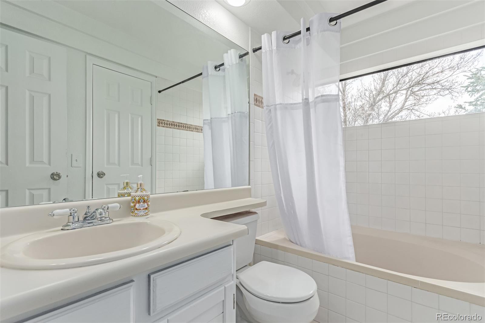 2675 South Deframe Circle Lakewood, CO 80228 - Photo 16 of 28 a bathroom with a sink a toilet and shower