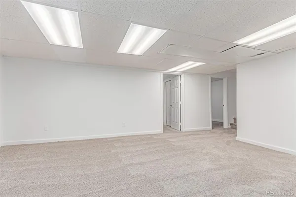 an empty room with windows and closet