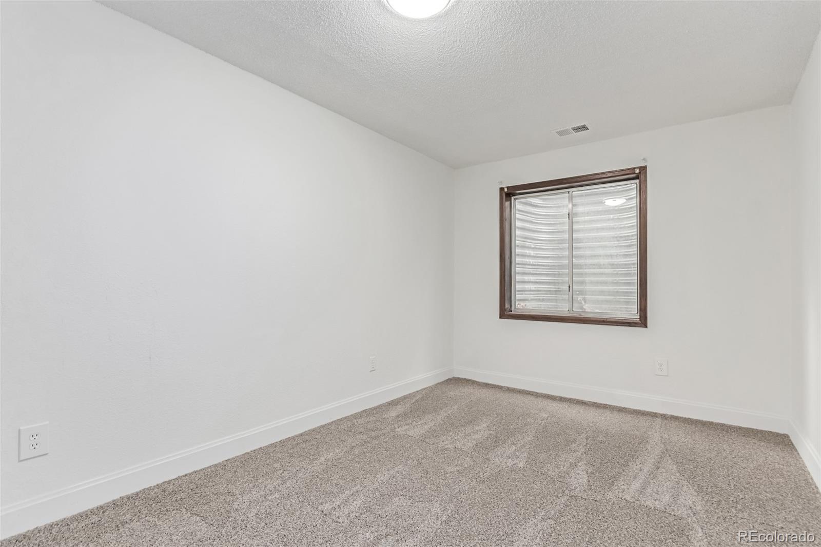 2675 South Deframe Circle Lakewood, CO 80228 - Photo 21 of 28 an empty room with a window