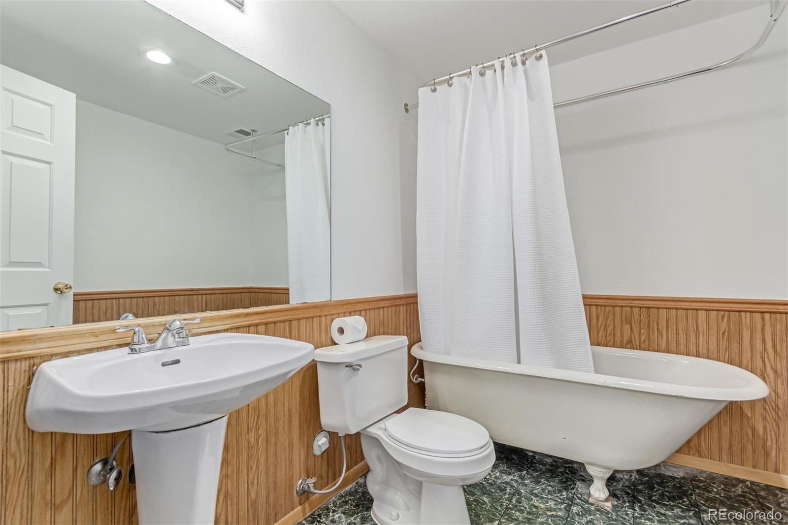2675 South Deframe Circle Lakewood, CO 80228 - Photo 22 of 28 a bathroom with a sink toilet and shower