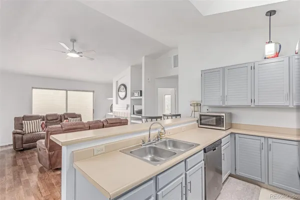 a kitchen with a sink stove and cabinets