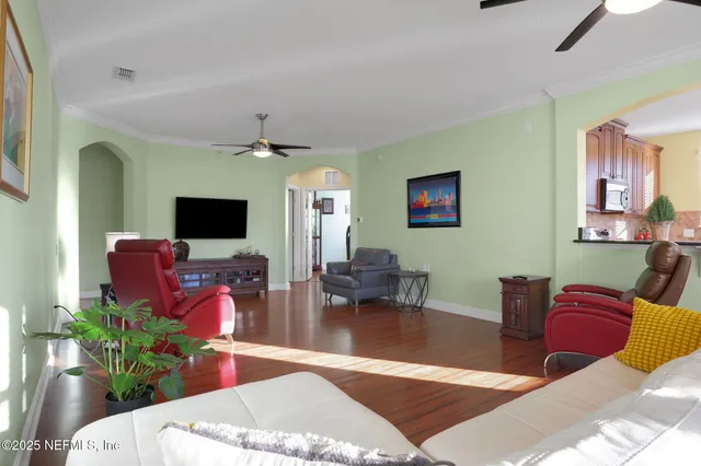 a living room with furniture a flat screen tv and a fireplace