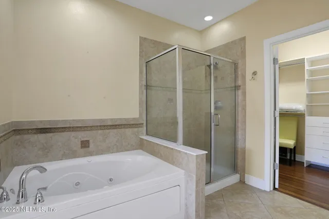 a bathroom with a bathtub and a shower