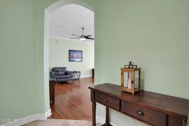 a view of a workspace with furniture and wooden floor